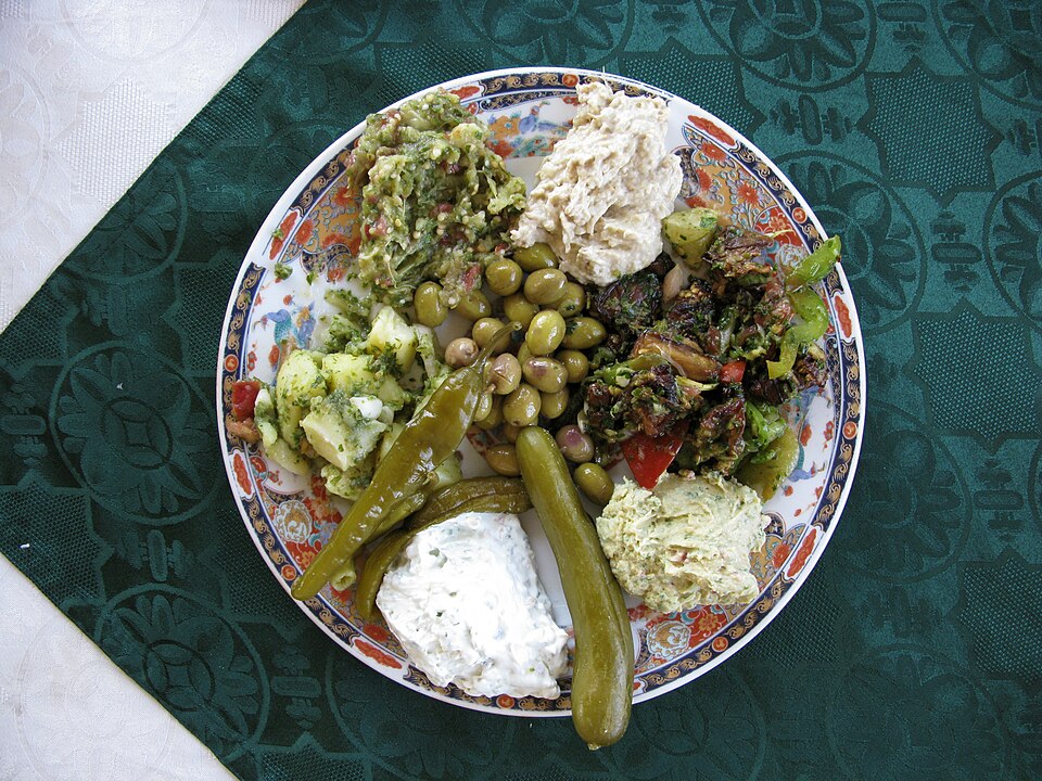 Syrian meze table with olives, dips, vegetables and bread