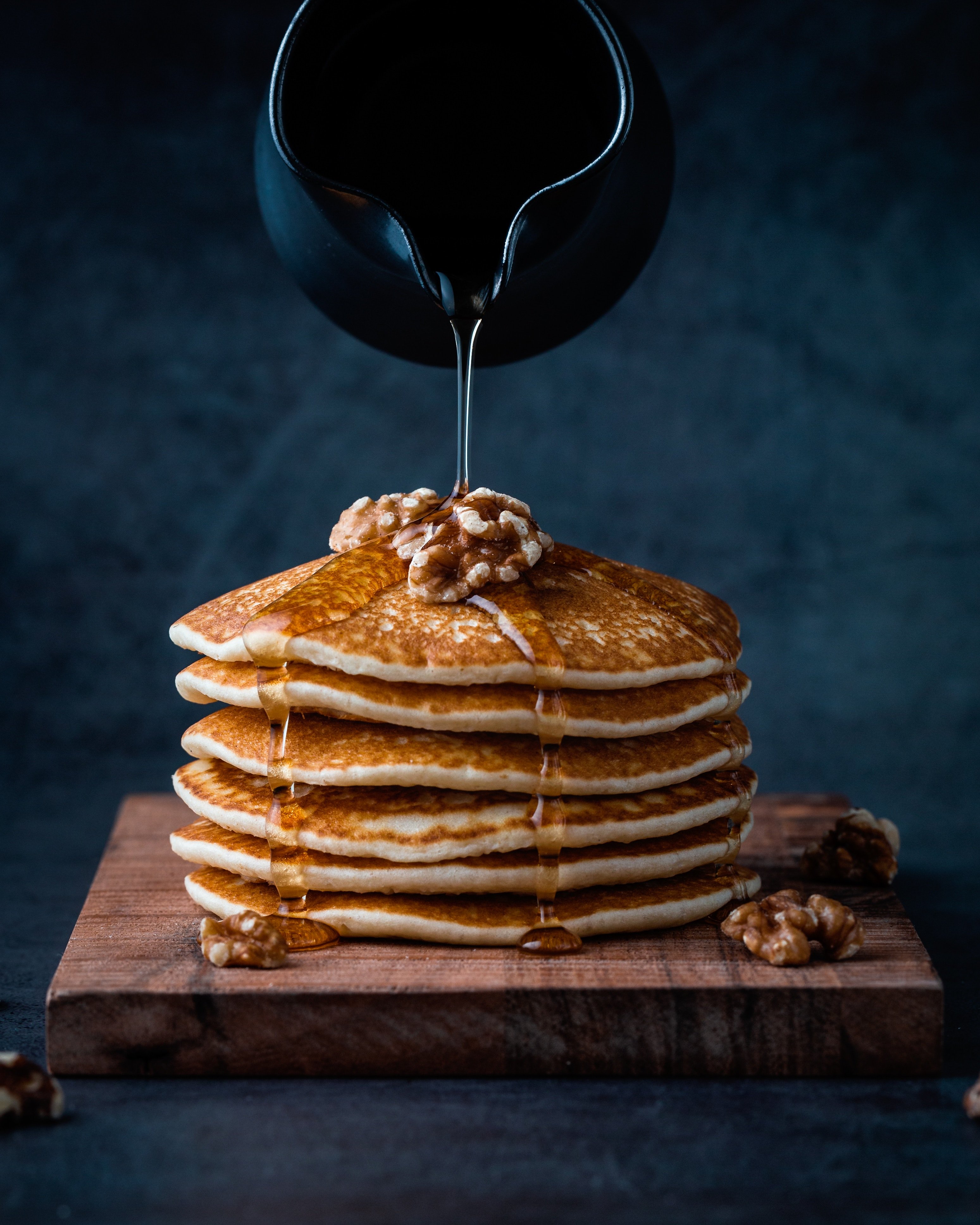 Stack of pancakes with walnuts and honey